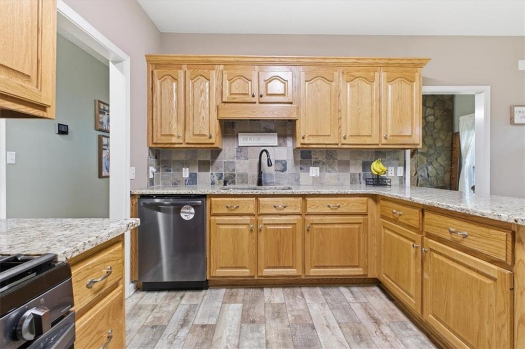 164 Laurens Road Rockmart, GA 30153 - Photo 14 of 41 a kitchen with stainless steel appliances granite countertop a sink stove and cabinets