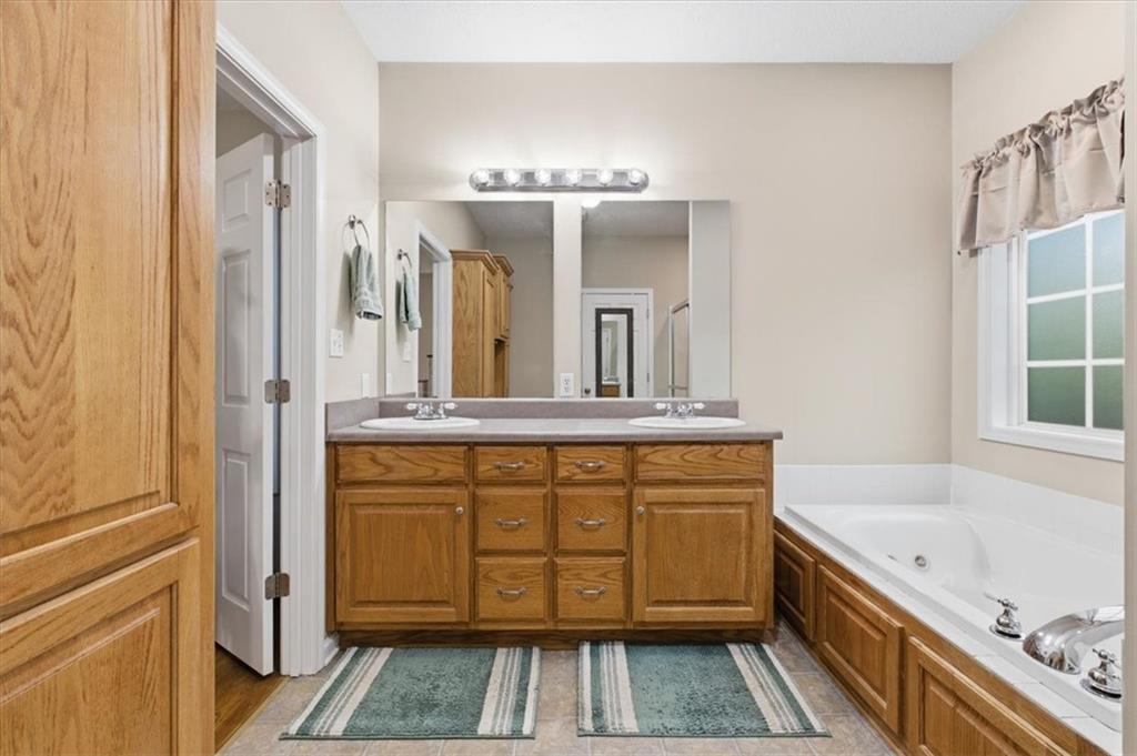 164 Laurens Road Rockmart, GA 30153 - Photo 20 of 41 a bathroom with a tub sink and mirror