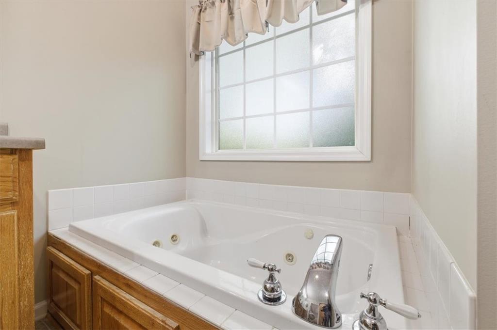 164 Laurens Road Rockmart, GA 30153 - Photo 21 of 41 a bathroom with a tub and a window