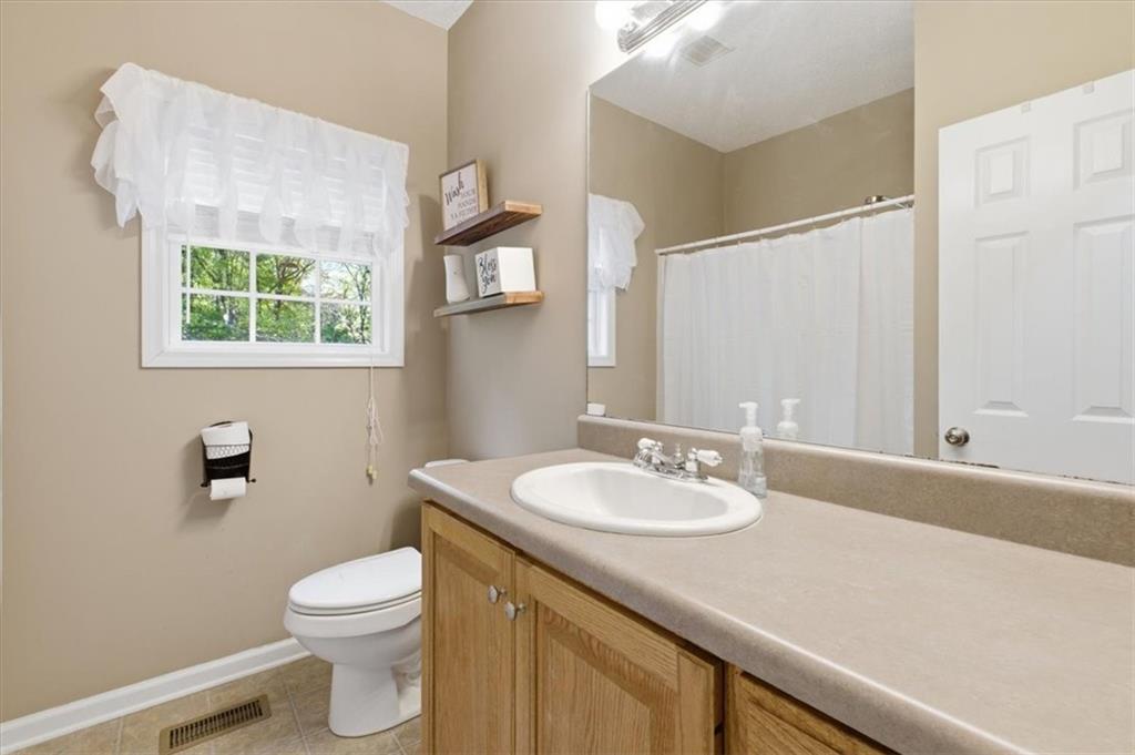 164 Laurens Road Rockmart, GA 30153 - Photo 26 of 41 a bathroom with a sink a toilet and a mirror