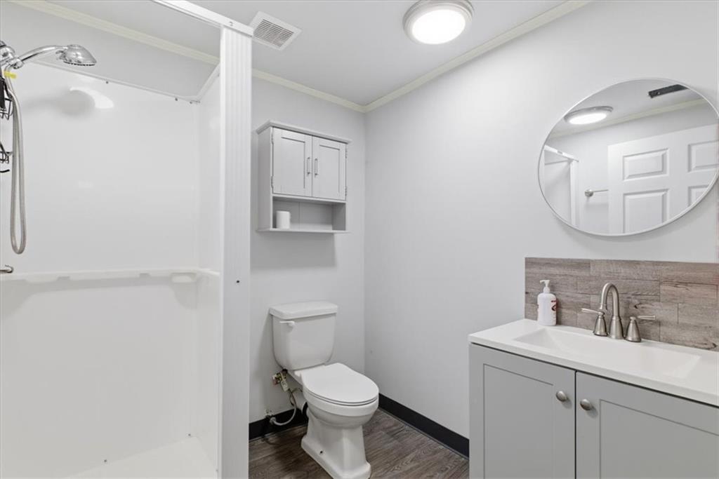 164 Laurens Road Rockmart, GA 30153 - Photo 36 of 41 a bathroom with a toilet sink and mirror