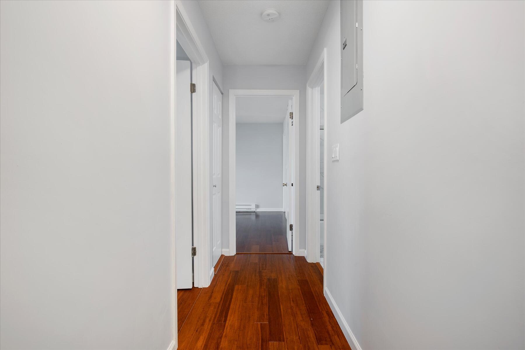 800 Bearses Way, Unit 1EB Hyannis, MA 02601 - Photo 15 of 37 a view of a hallway with wooden floor and staircase