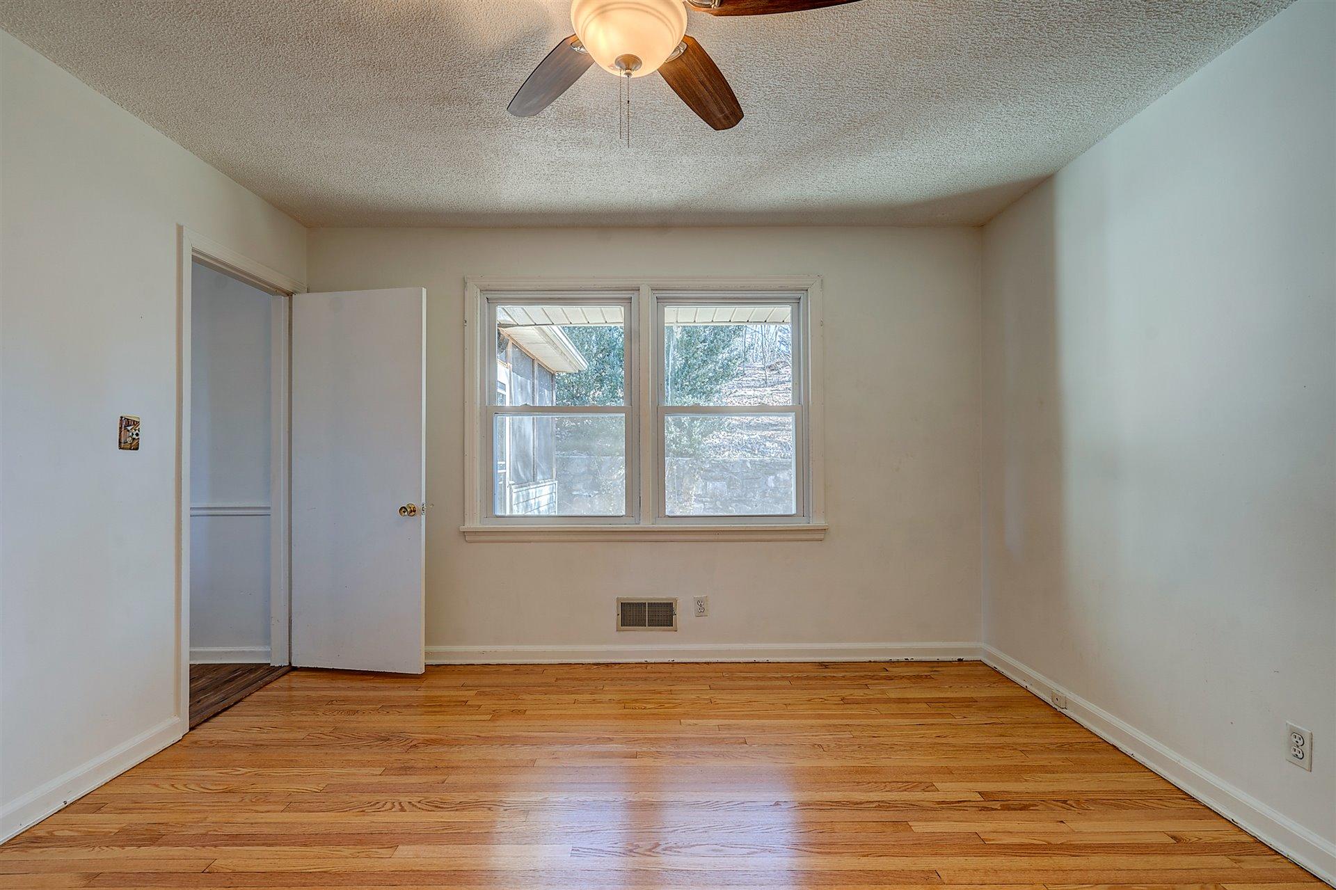 3026 Sedgefield Road Southwest Roanoke, VA 24018 - Photo 11 of 25 wooden floor in an empty room with a window