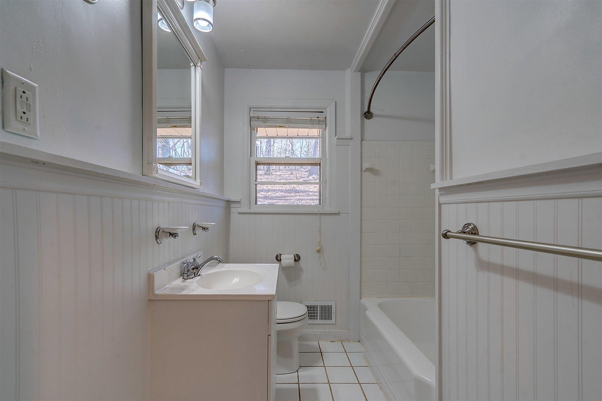 3026 Sedgefield Road Southwest Roanoke, VA 24018 - Photo 12 of 25 a bathroom with a sink a toilet and shower