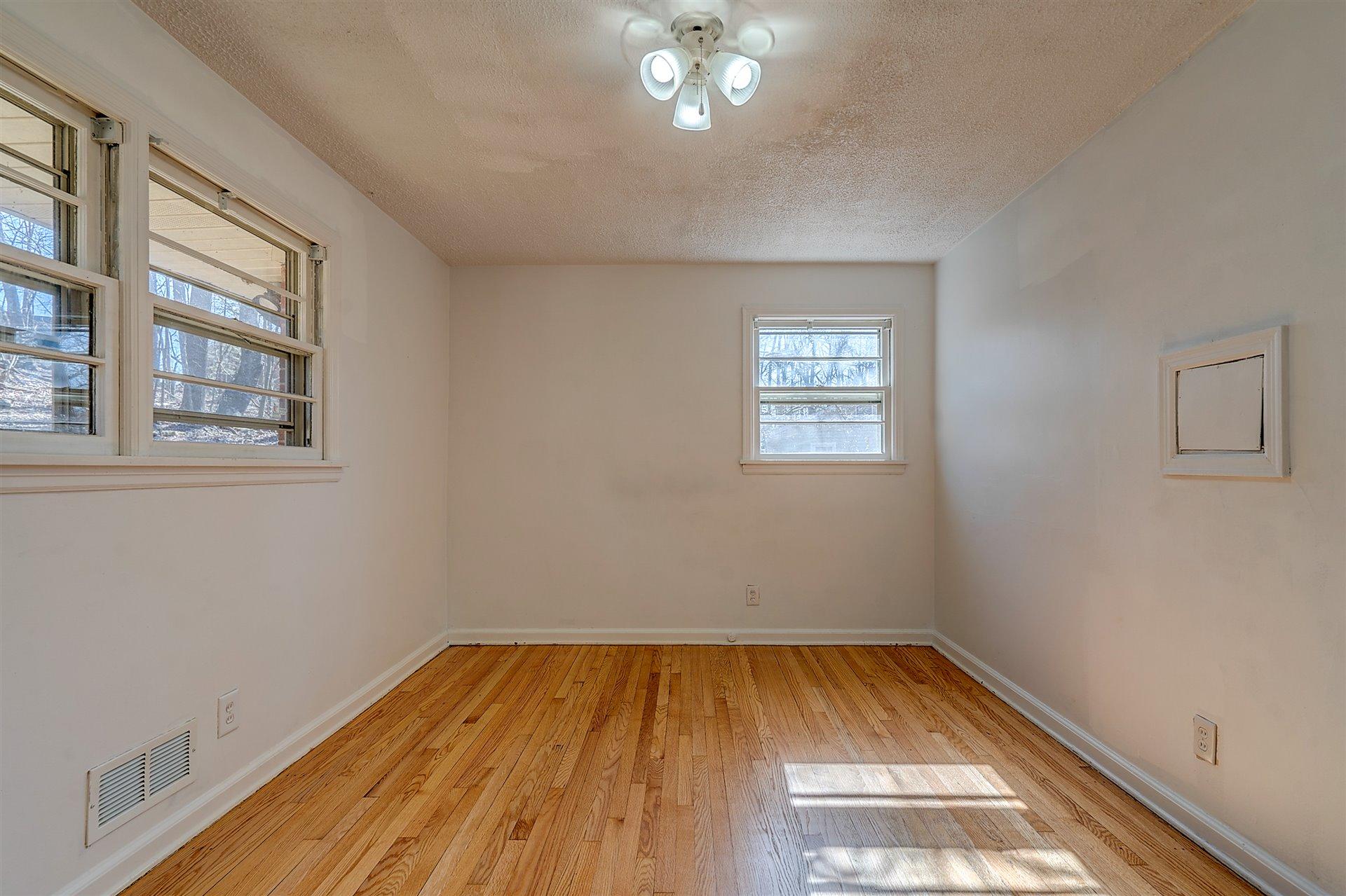 3026 Sedgefield Road Southwest Roanoke, VA 24018 - Photo 13 of 25 a view of a room with wooden floor and a window