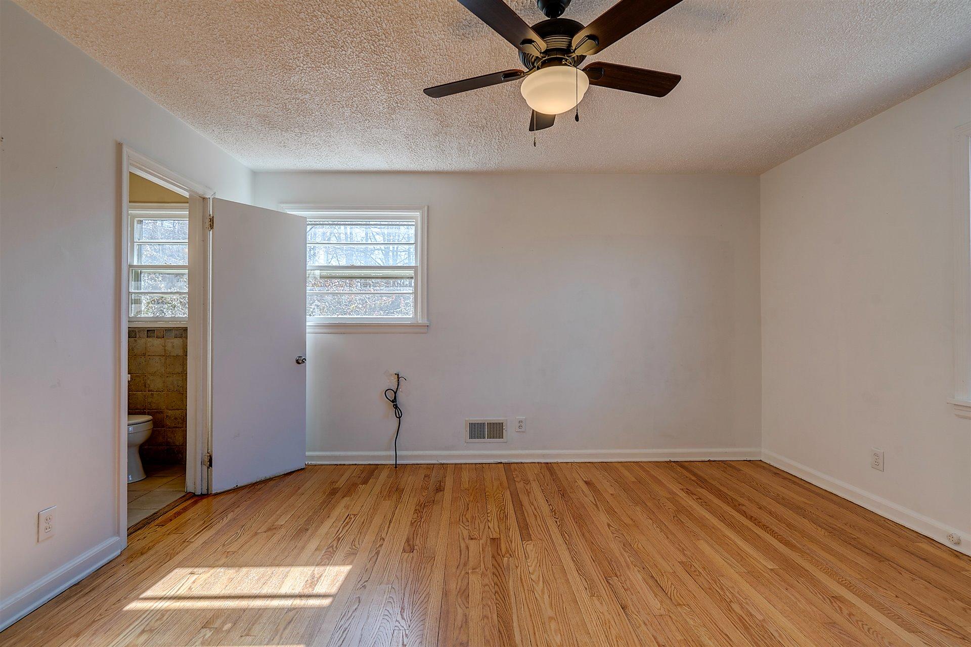 3026 Sedgefield Road Southwest Roanoke, VA 24018 - Photo 14 of 25 wooden floor in an empty room with a window