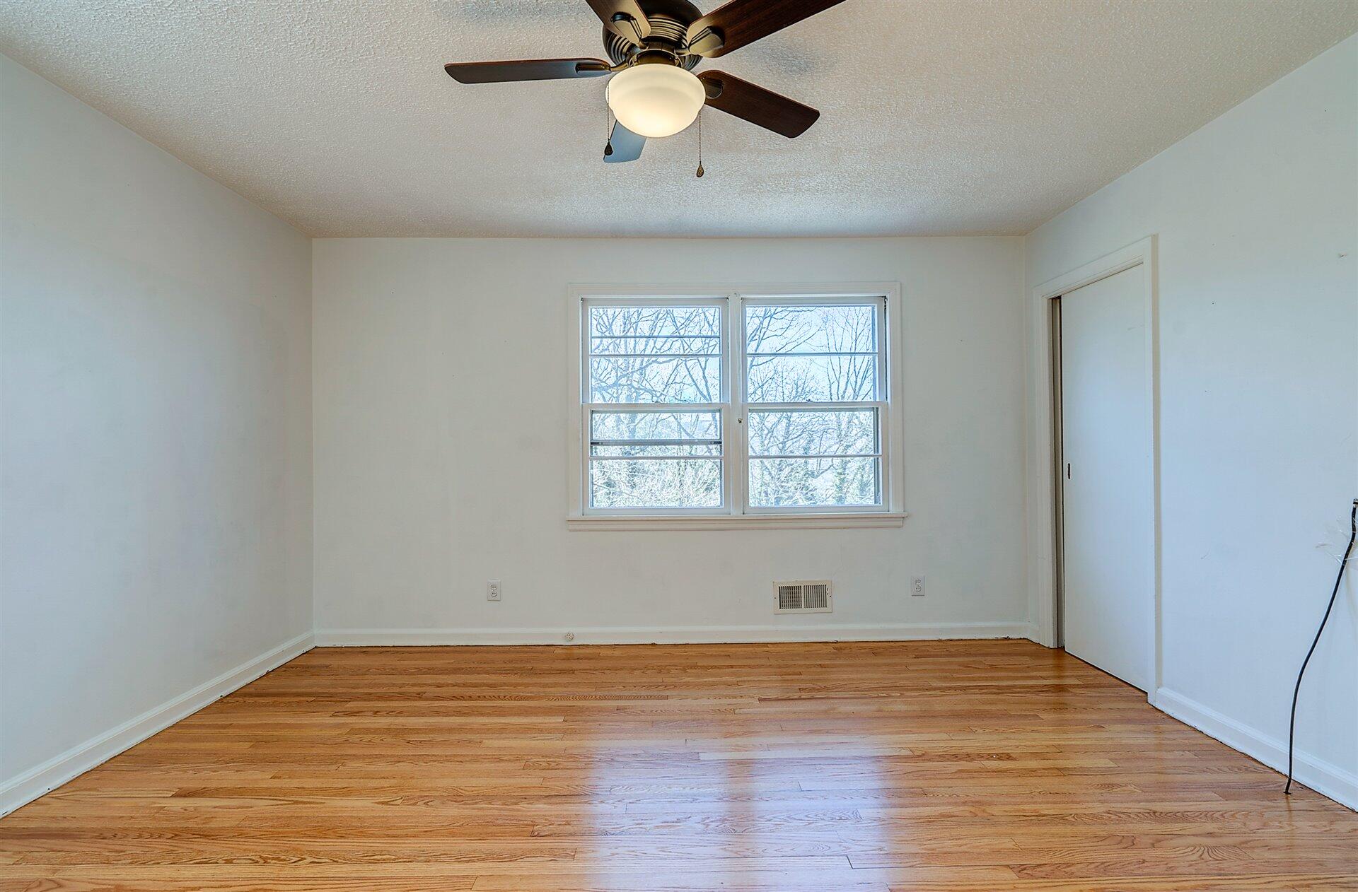 3026 Sedgefield Road Southwest Roanoke, VA 24018 - Photo 15 of 25 wooden floor in an empty room with a window