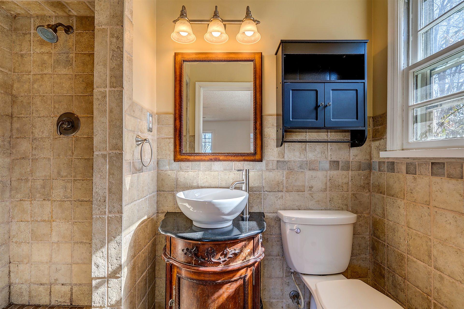 3026 Sedgefield Road Southwest Roanoke, VA 24018 - Photo 16 of 25 a bathroom with a toilet a sink and mirror