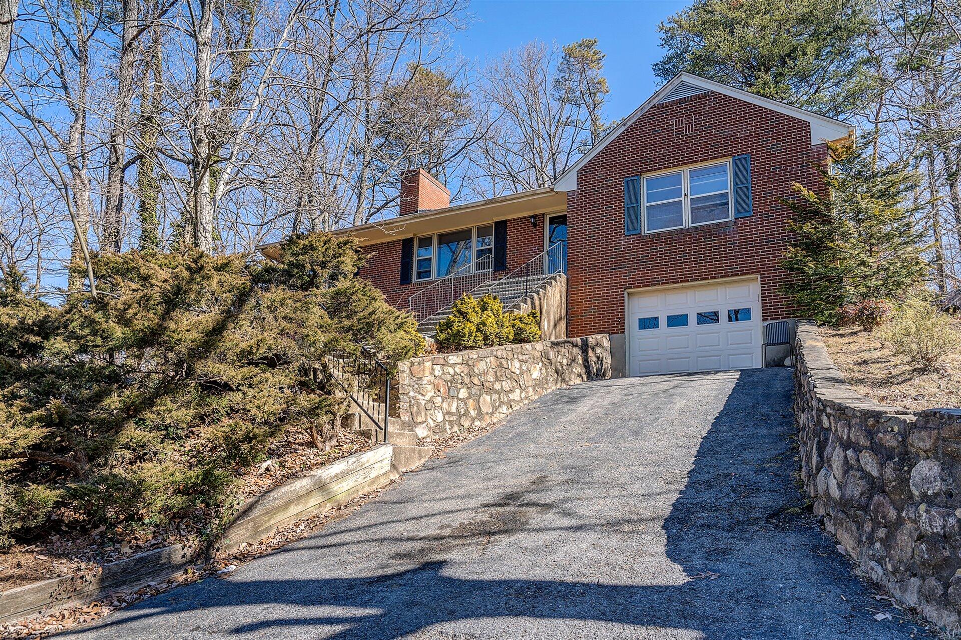 3026 Sedgefield Road Southwest Roanoke, VA 24018 - Photo 25 of 25 a front view of a house with a yard and garage