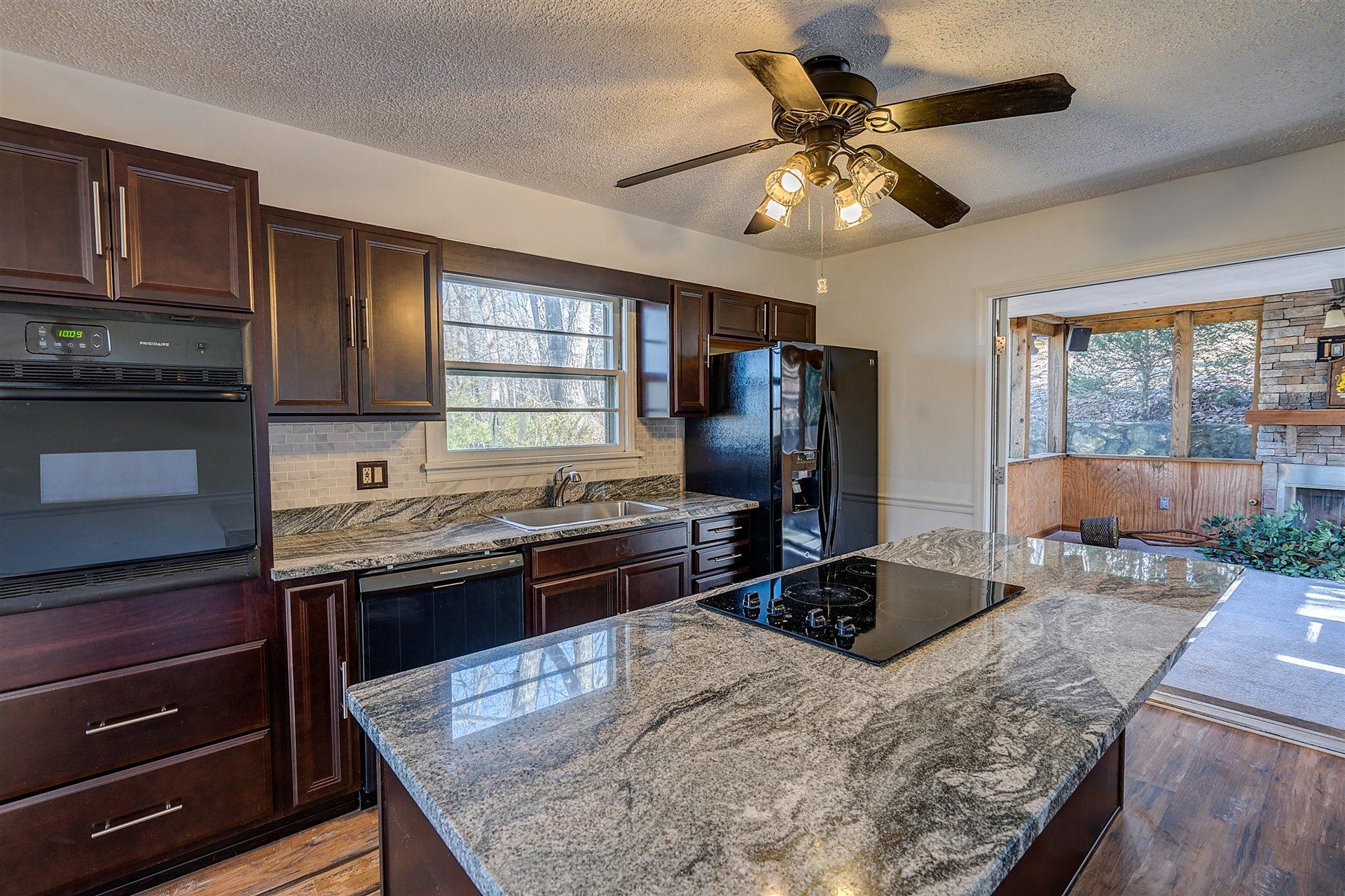 3026 Sedgefield Road Southwest Roanoke, VA 24018 - Photo 6 of 25 a kitchen with stainless steel appliances granite countertop a sink stove and refrigerator