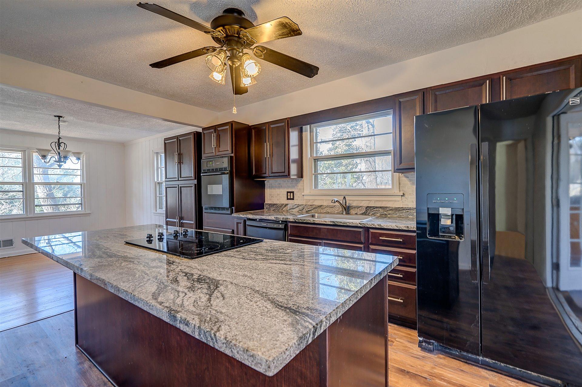 3026 Sedgefield Road Southwest Roanoke, VA 24018 - Photo 7 of 25 a kitchen with granite countertop a counter space cabinets and appliances