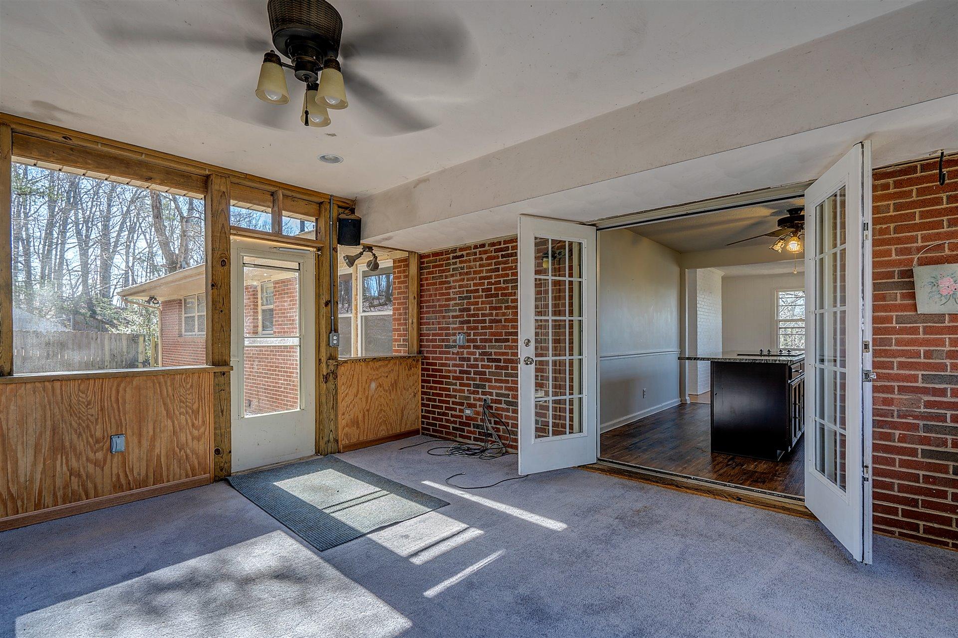 3026 Sedgefield Road Southwest Roanoke, VA 24018 - Photo 10 of 25 a view of an empty room with a fireplace and a window
