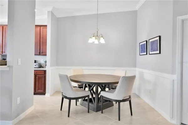a view of a dining room with furniture and a chandelier