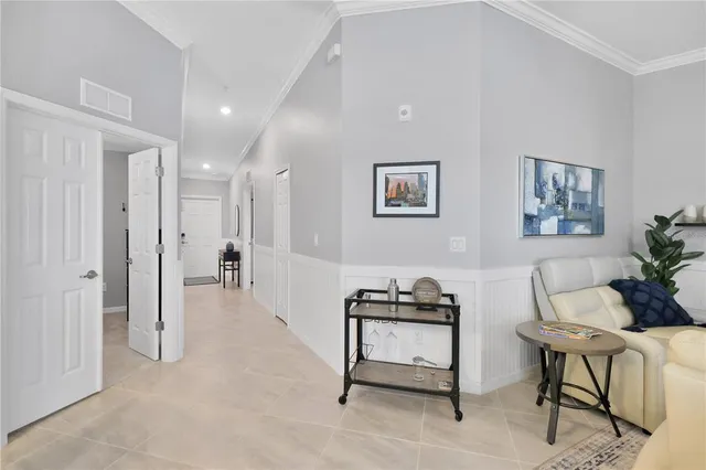 a living room with furniture a rug and white walls