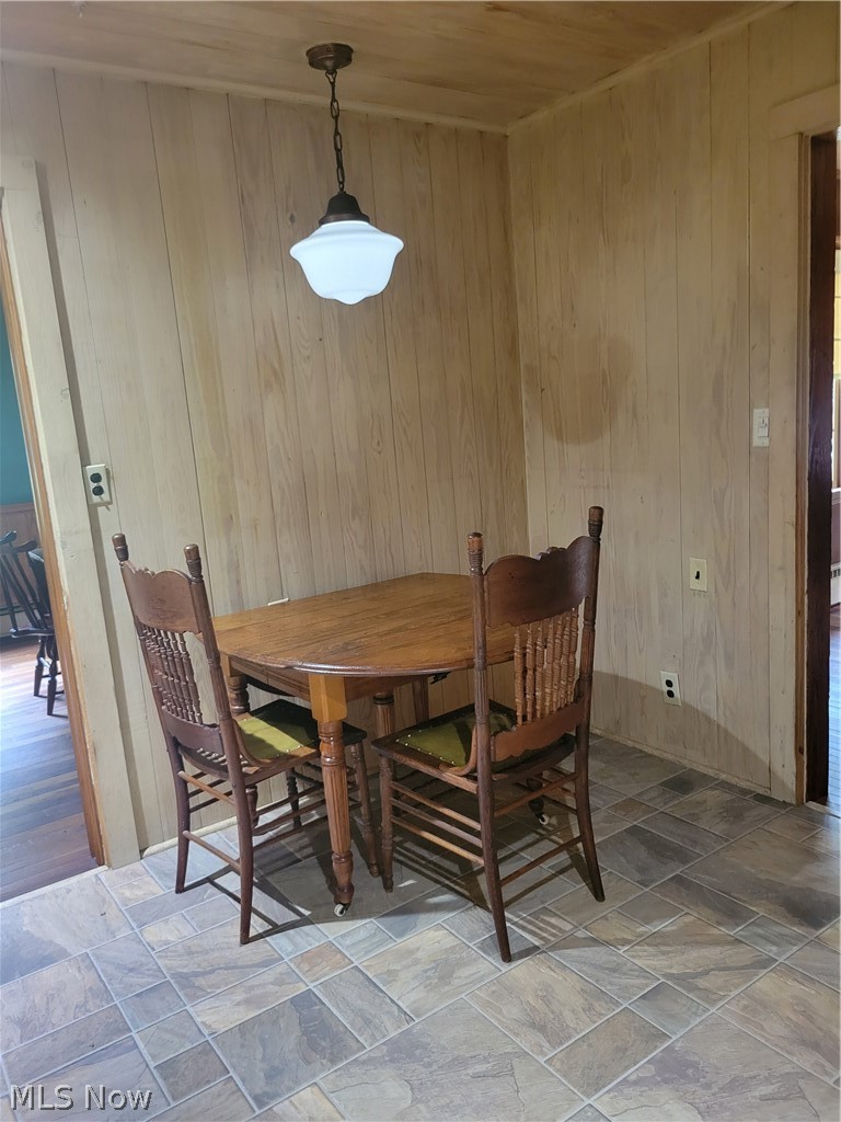 7357 Westview Road Kent, OH 44240 - Photo 15 of 30 Dining room featuring wood ceiling, wooden walls, and tile patterned floors