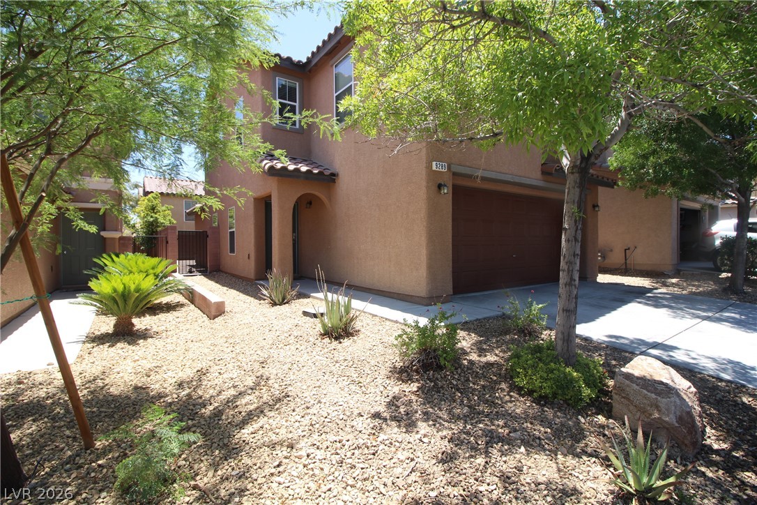 9289 Valley Ranch Avenue Las Vegas, NV 89178 - Photo 5 of 29 A well-maintained desert landscape frames this welcoming residence with an attached garage.