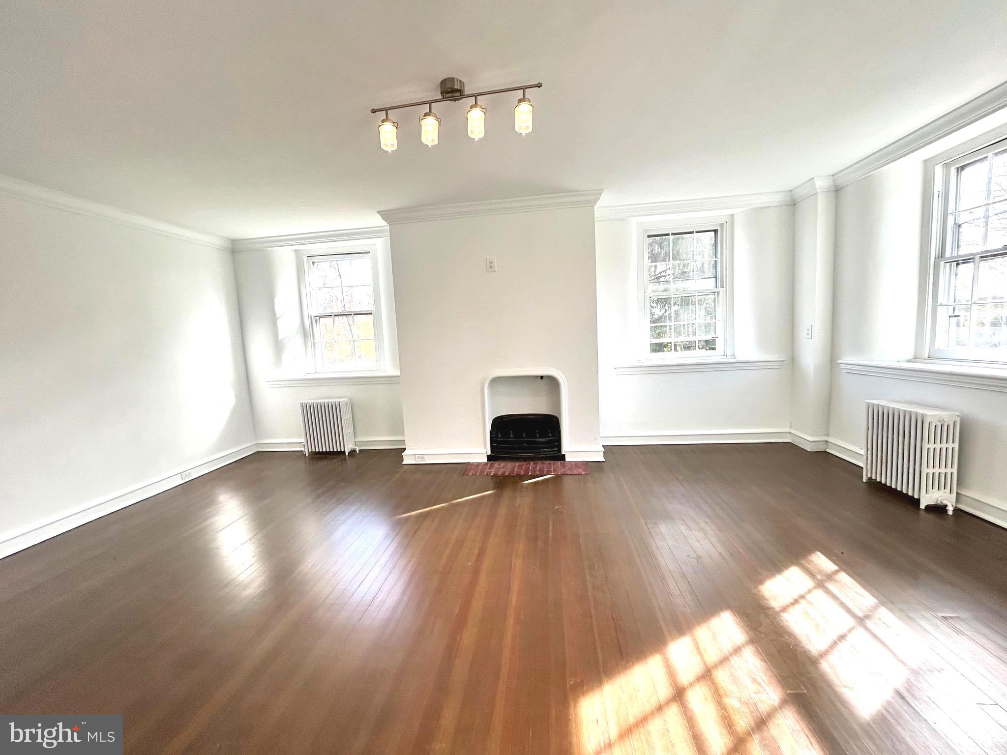 571 North Newtown Street Road Newtown Square, PA 19073 - Photo 16 of 25 a view of empty room with fireplace and wooden floor