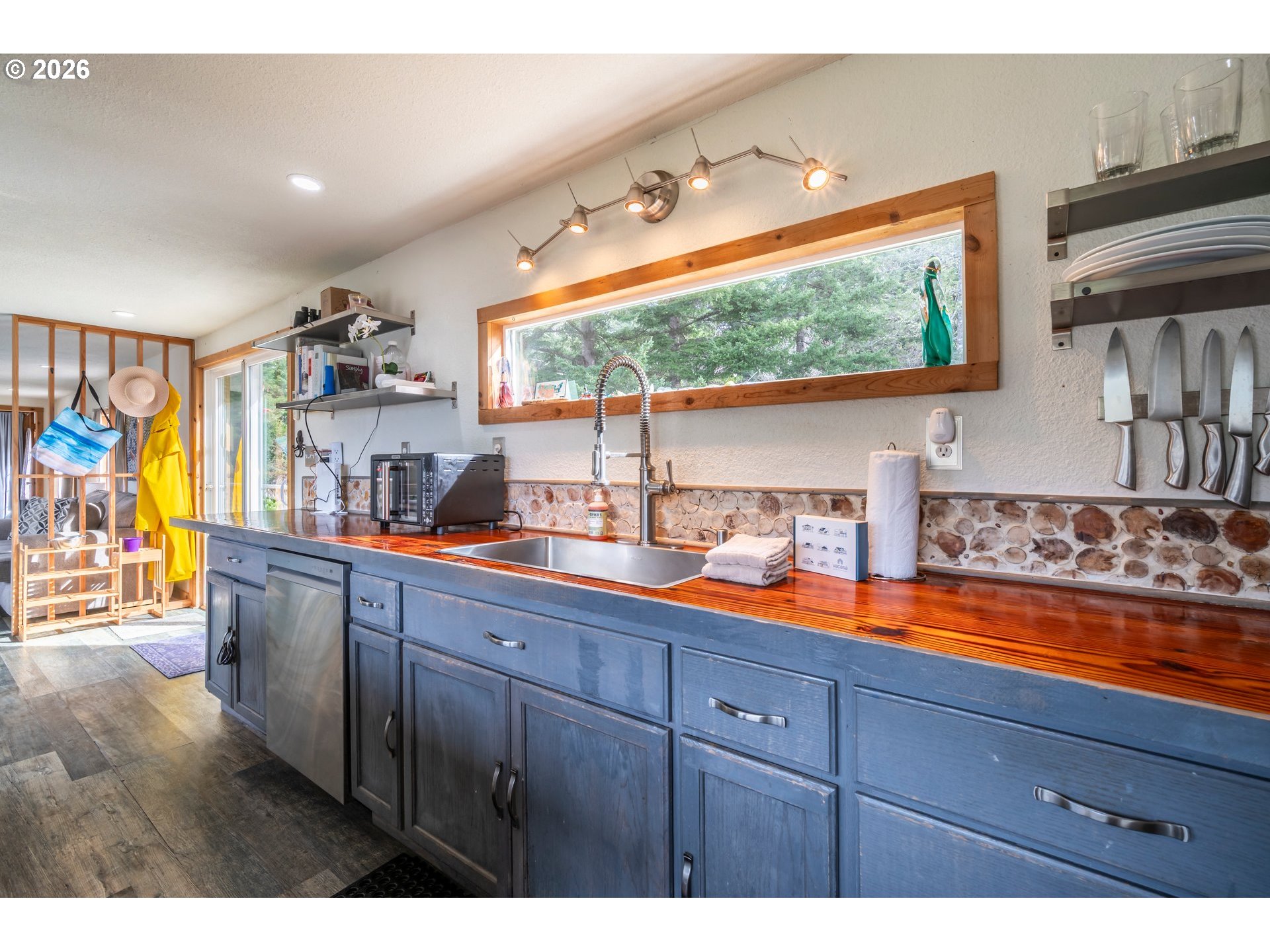 42365 Hensley Hill Road Port Orford, OR 97465 - Photo 17 of 47 a kitchen with stainless steel appliances a sink and a large window
