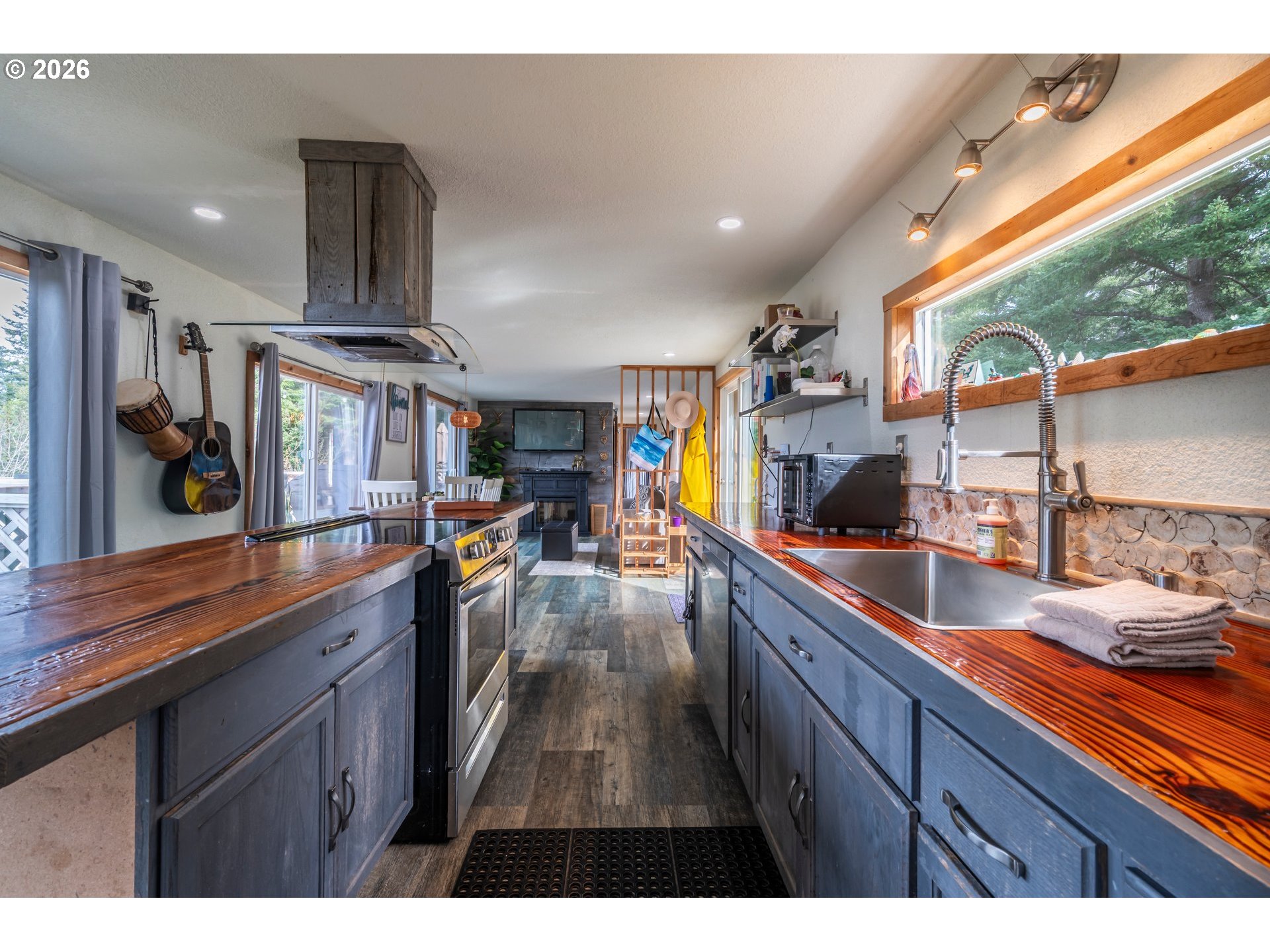 42365 Hensley Hill Road Port Orford, OR 97465 - Photo 20 of 47 a kitchen with stainless steel appliances a sink a stove and a wooden floor