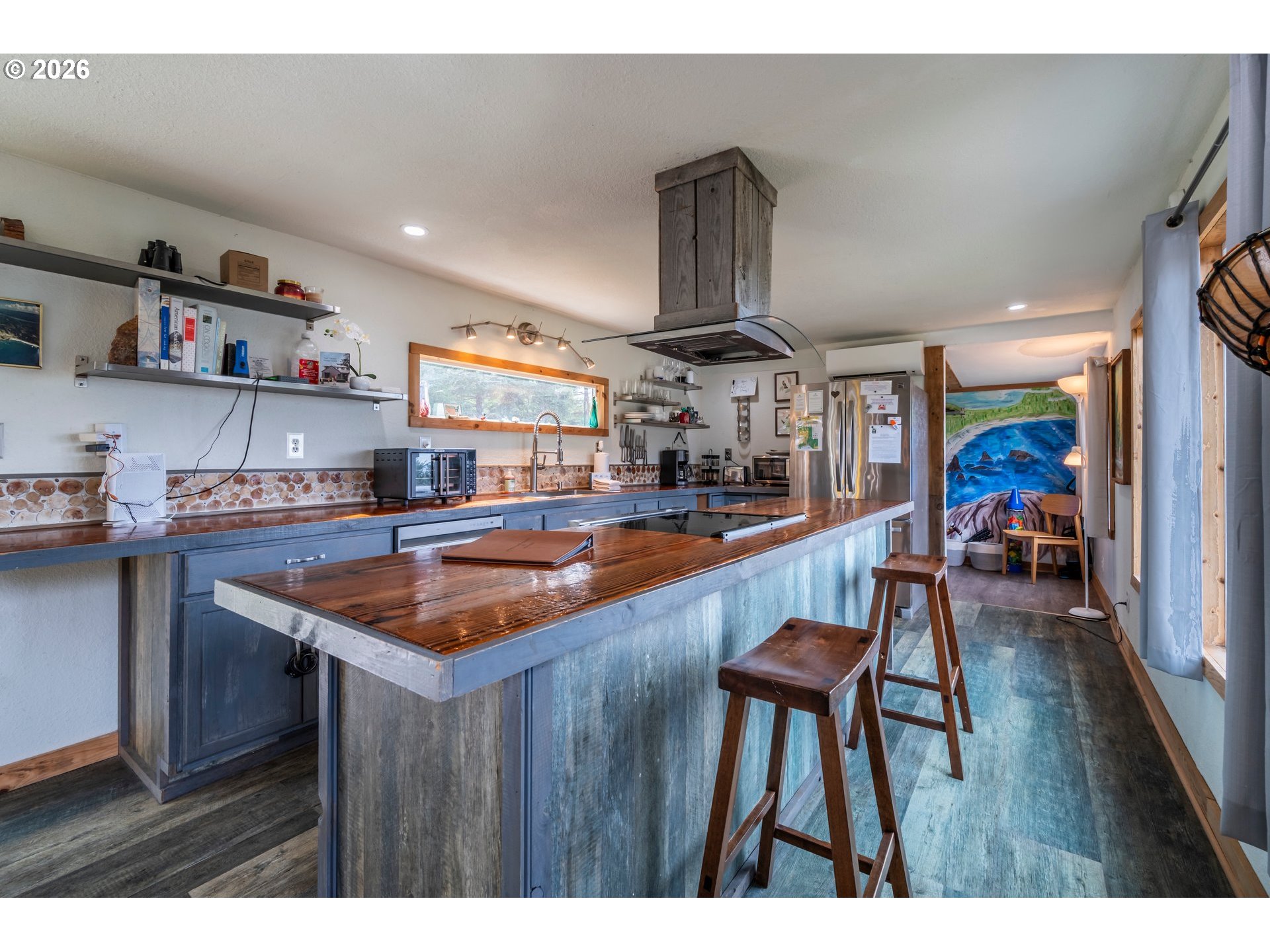 42365 Hensley Hill Road Port Orford, OR 97465 - Photo 22 of 47 a kitchen with stainless steel appliances granite countertop table chairs and wooden floor