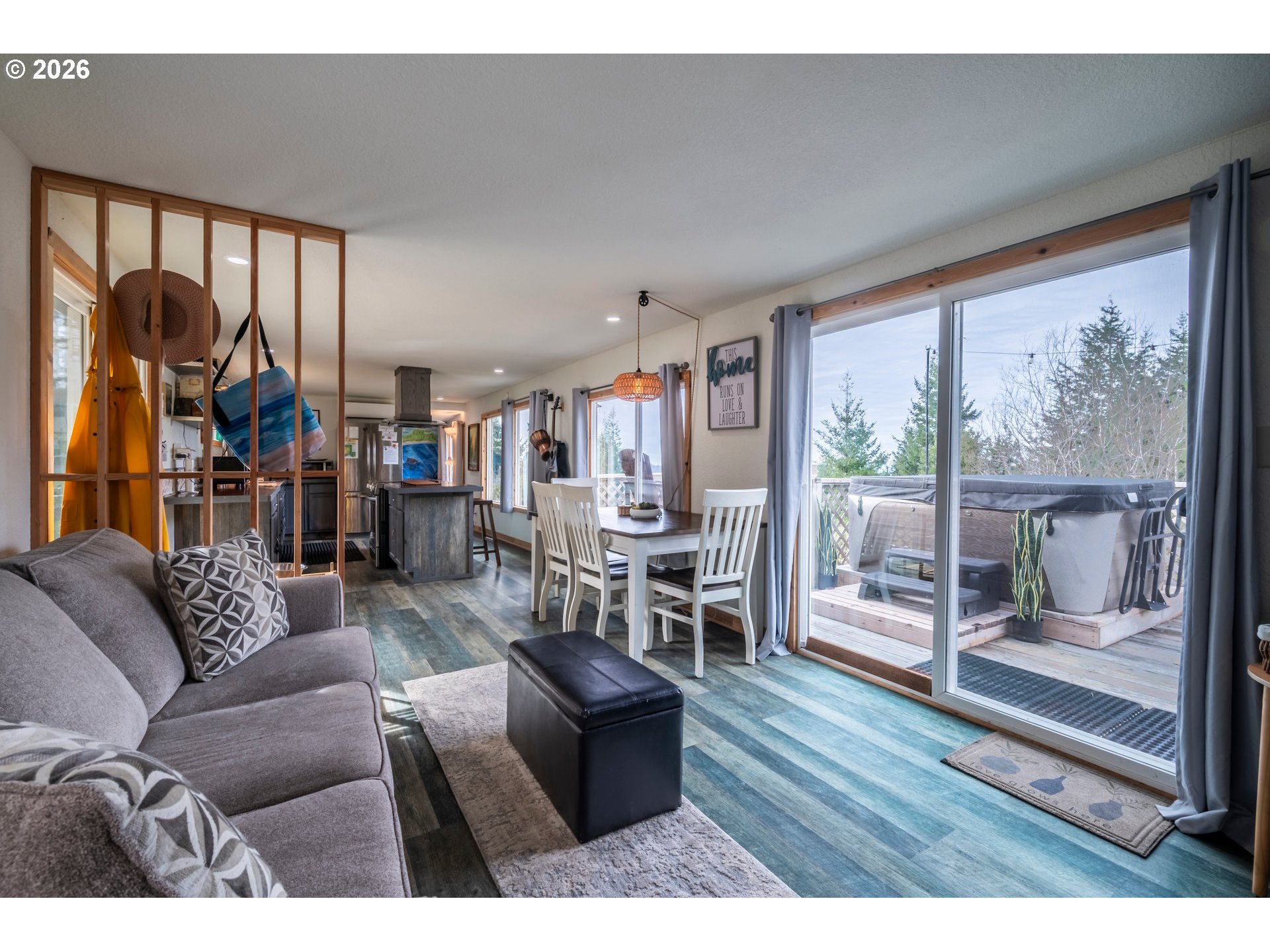 42365 Hensley Hill Road Port Orford, OR 97465 - Photo 25 of 47 a living room with furniture and a floor to ceiling window