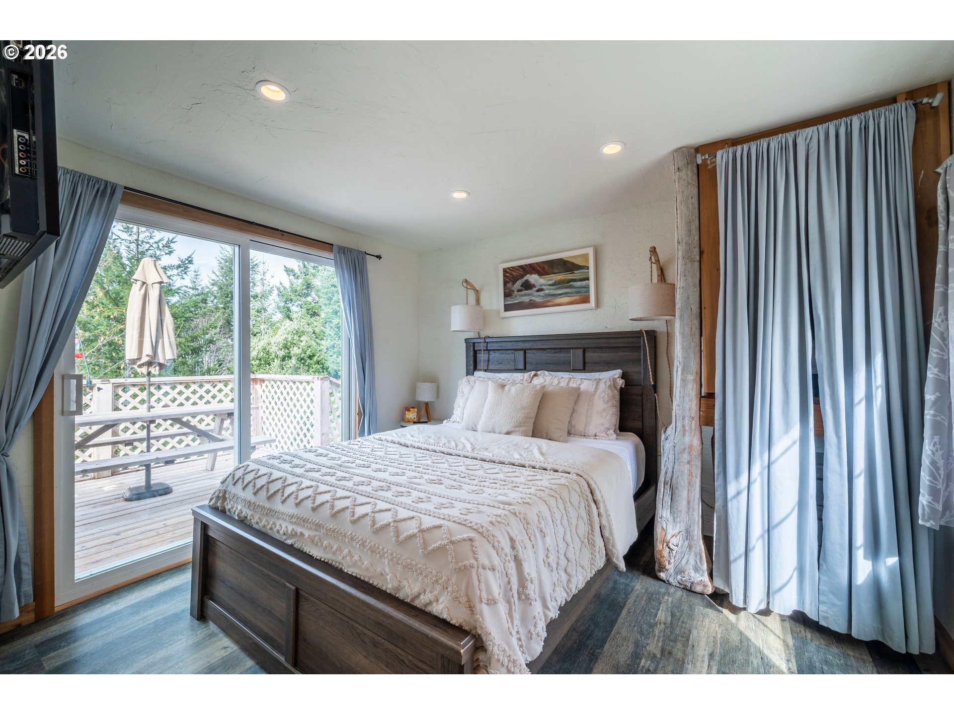 42365 Hensley Hill Road Port Orford, OR 97465 - Photo 31 of 47 a bedroom with a large bed and a large window