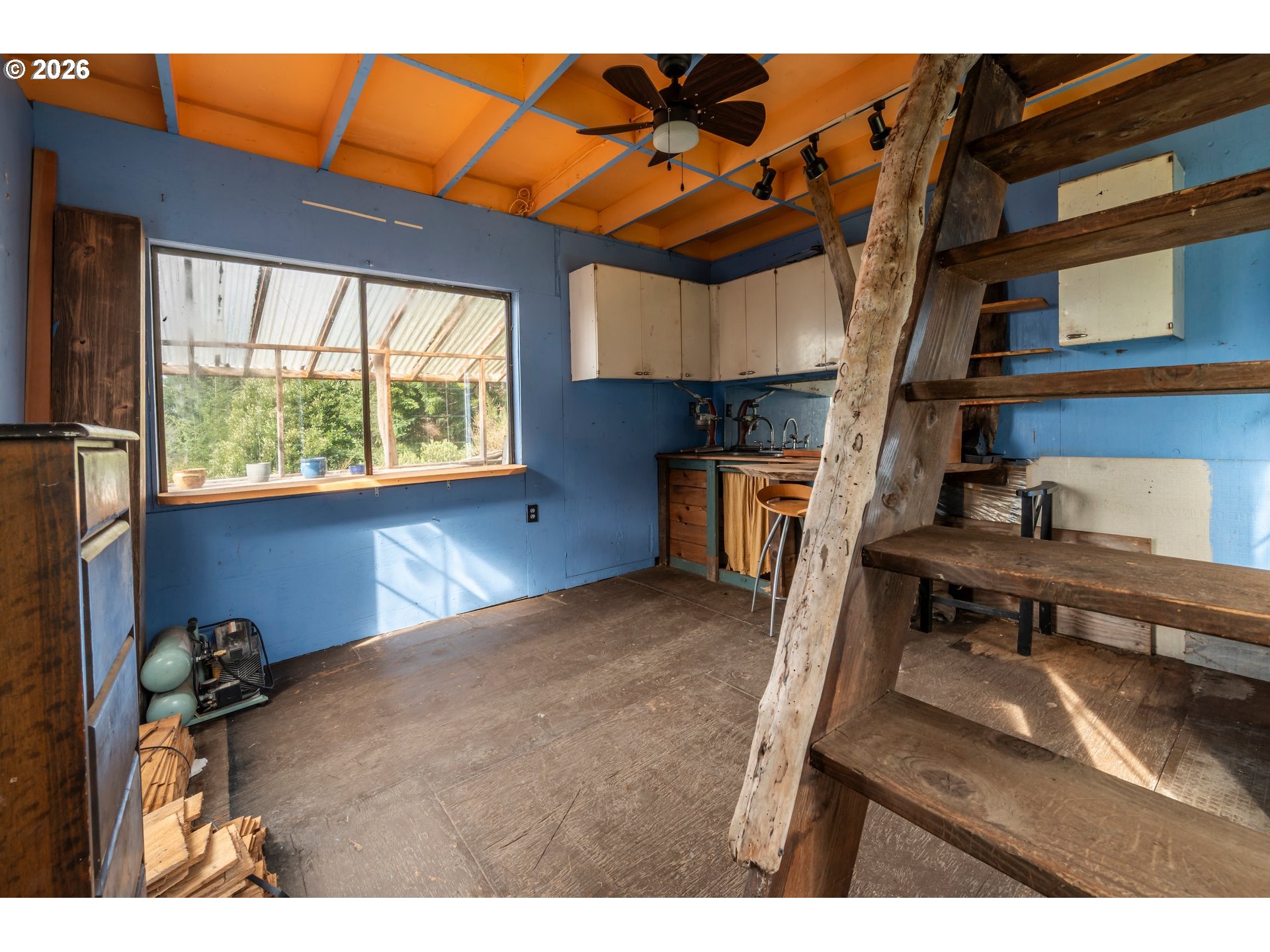 42365 Hensley Hill Road Port Orford, OR 97465 - Photo 38 of 47 a kitchen with stainless steel appliances kitchen island a table chairs in it and wooden floor