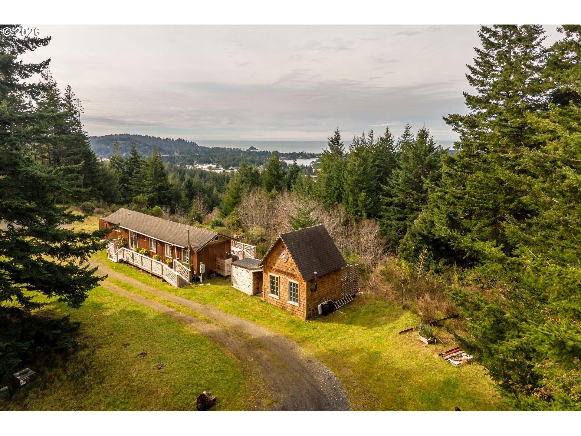 42365 Hensley Hill Road Port Orford, OR 97465 - Photo 40 of 47 a view of a swimming pool with an ocean and trees in the background