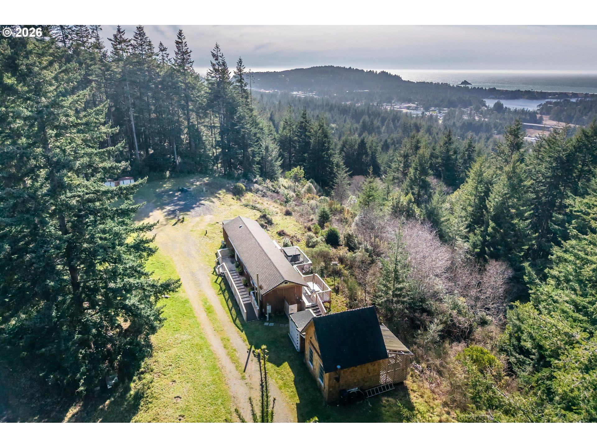 42365 Hensley Hill Road Port Orford, OR 97465 - Photo 6 of 47 a view of a house with a mountain in the background
