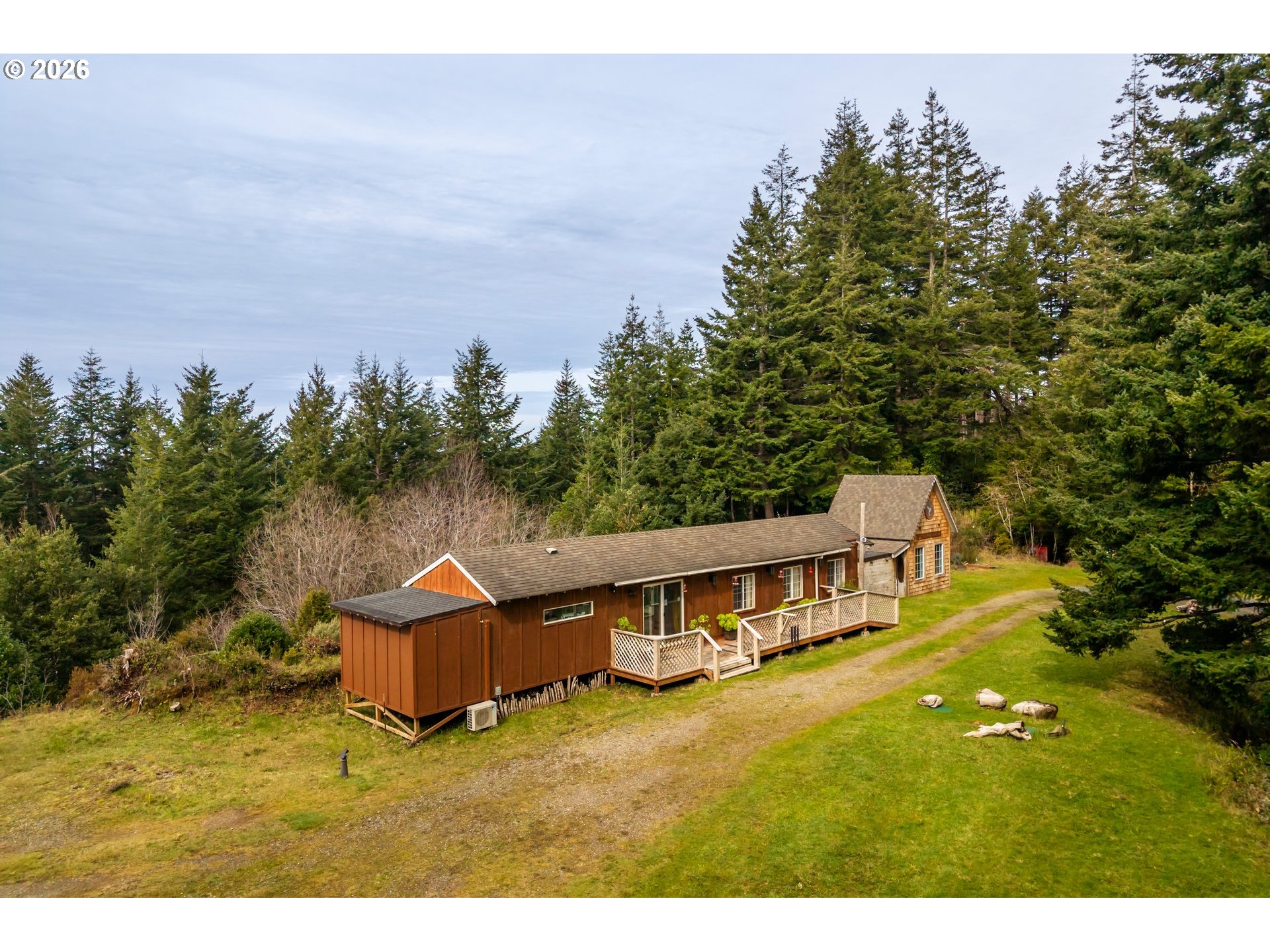 42365 Hensley Hill Road Port Orford, OR 97465 - Photo 8 of 47 a view of a house with a yard and sitting area