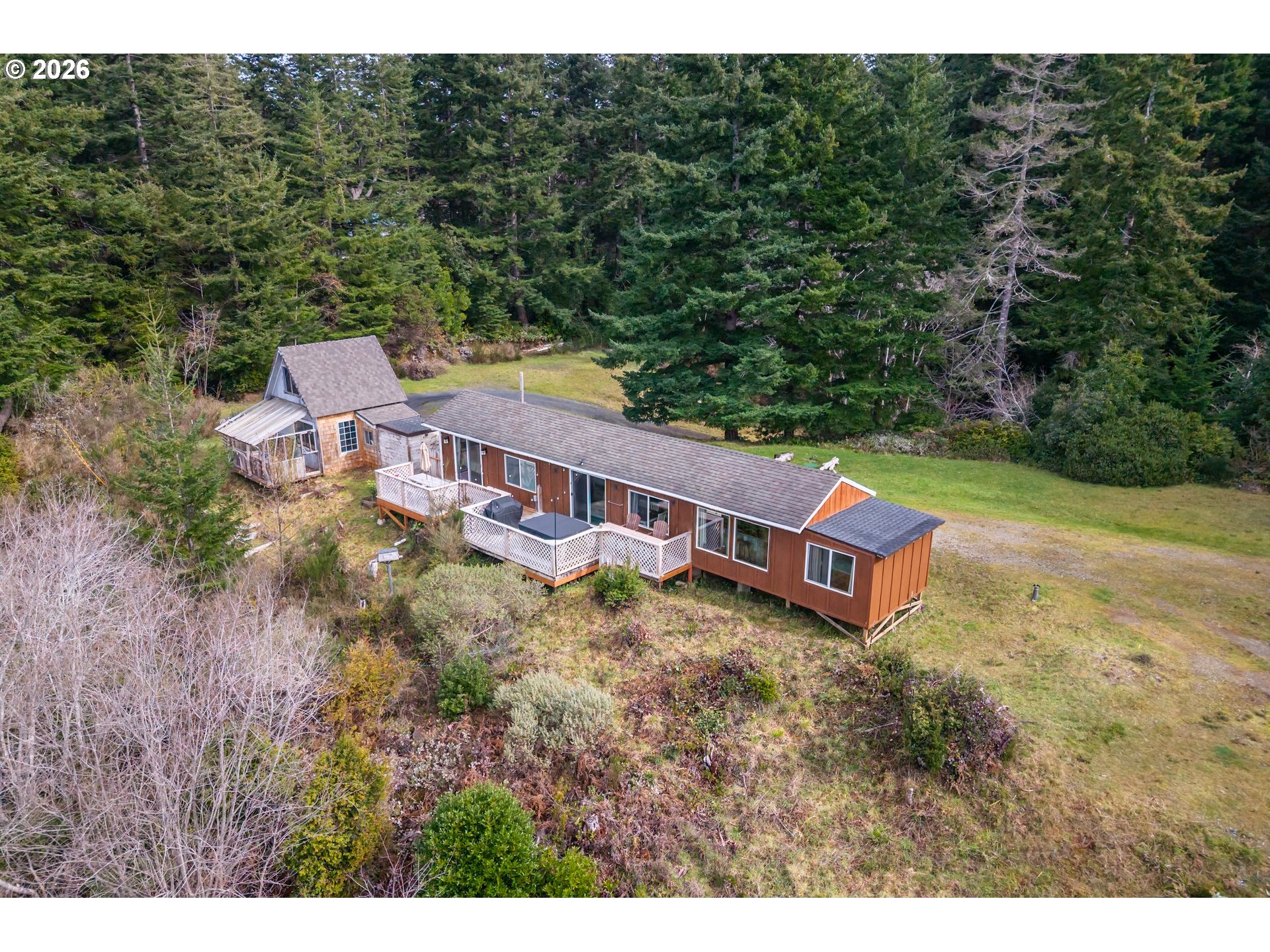 42365 Hensley Hill Road Port Orford, OR 97465 - Photo 9 of 47 a view of a house with a yard and fence