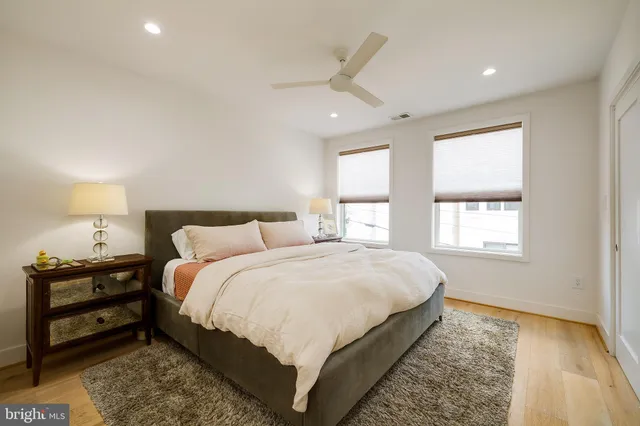 a large bedroom with bed and window