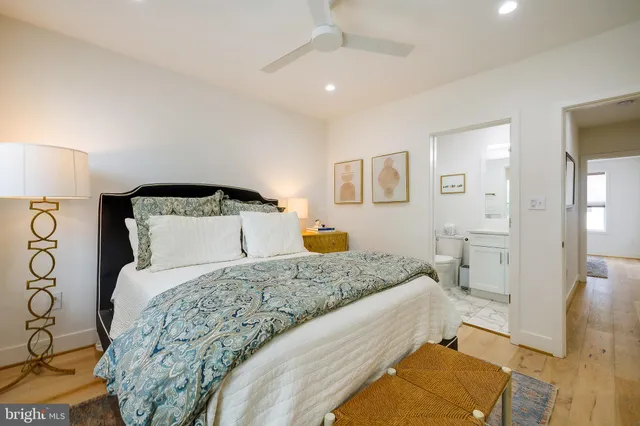 a bedroom with a large bed and a chandelier