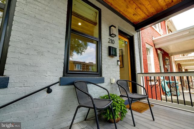 a balcony with chairs and wooden floor