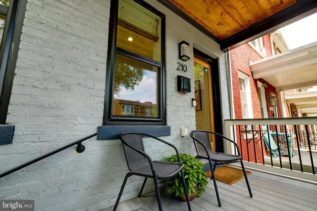 a balcony with chairs and wooden floor