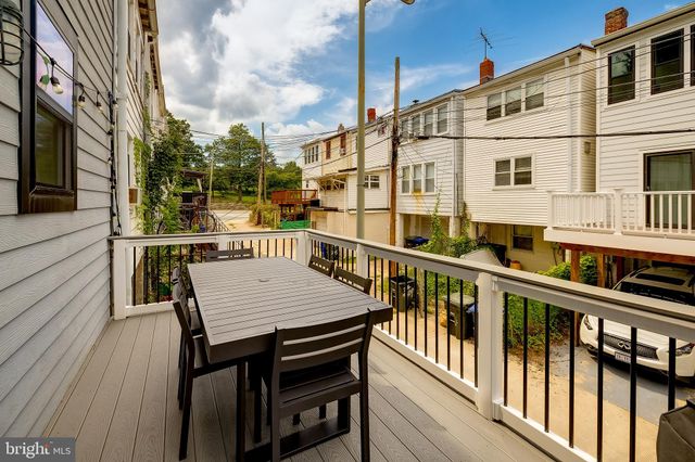 a view of a balcony with two chairs and a table