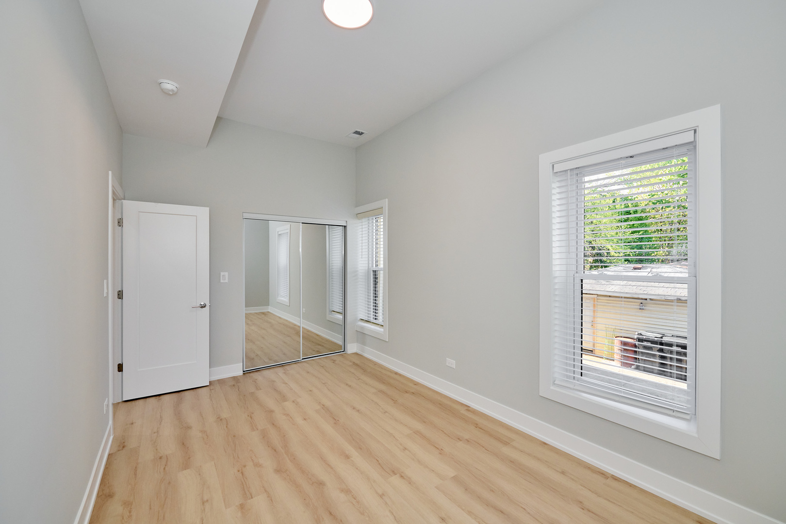 2868 West 21st Place, Unit 1 Chicago, IL 60623 - Photo 13 of 17 wooden floor in an empty room with a window