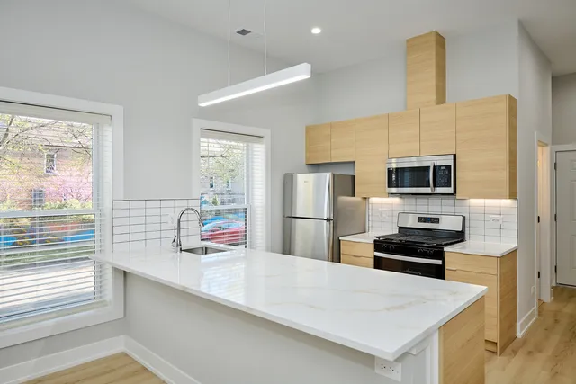 a kitchen with stainless steel appliances a microwave and refrigerator