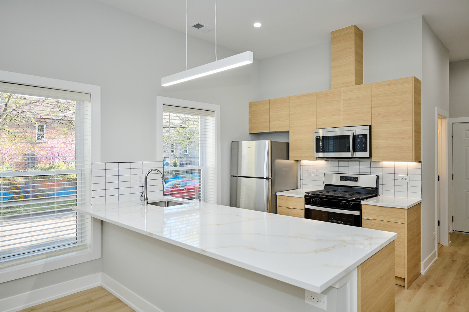 2868 West 21st Place, Unit 1 Chicago, IL 60623 - Photo 3 of 17 a kitchen with stainless steel appliances a microwave and refrigerator