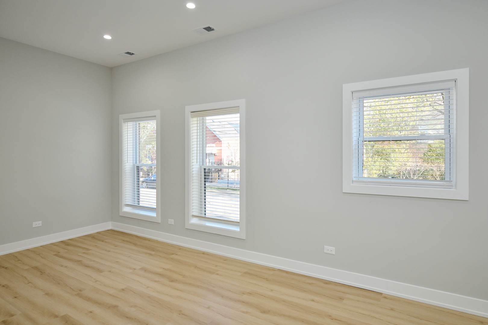 2868 West 21st Place, Unit 1 Chicago, IL 60623 - Photo 4 of 17 an empty room with wooden floor and windows