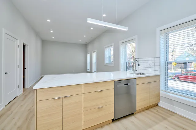a spacious bathroom with a granite countertop sink a mirror and a shower