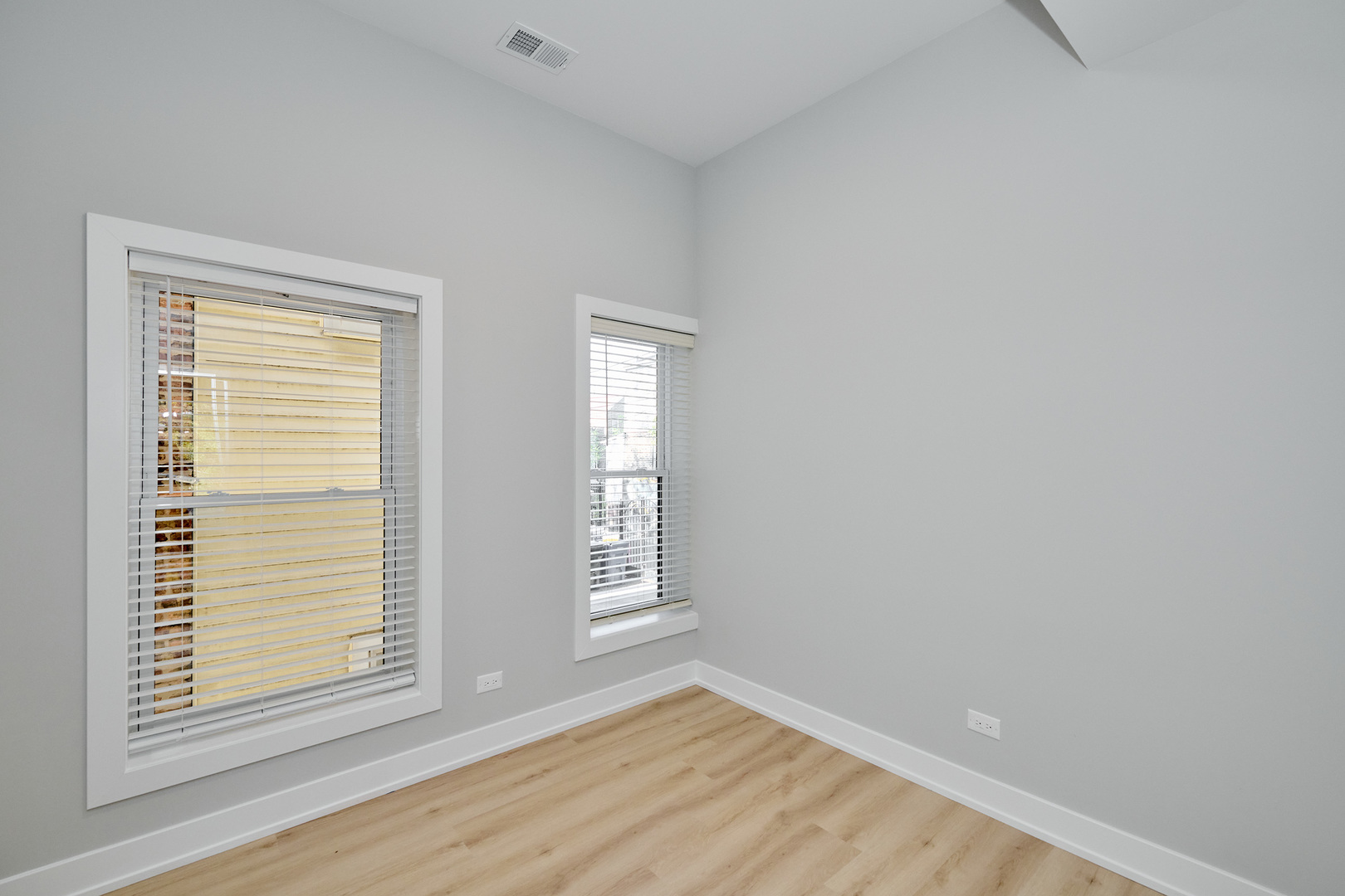 2868 West 21st Place, Unit 1 Chicago, IL 60623 - Photo 8 of 17 a view of an empty room with wooden floor and a window