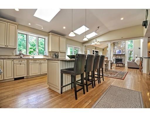 17 Deerfield Drive Medfield, MA 02052 - Photo 12 of 42 a kitchen with stainless steel appliances kitchen island granite countertop a table chairs and a view of living room