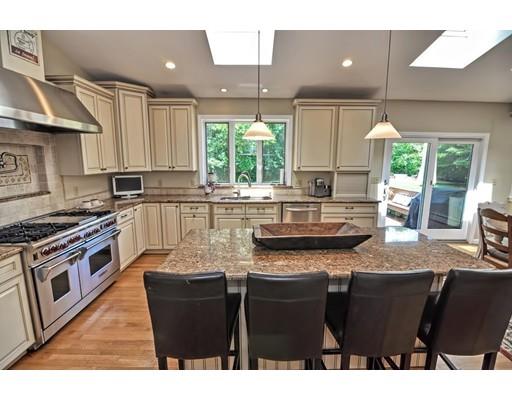 17 Deerfield Drive Medfield, MA 02052 - Photo 13 of 42 a kitchen with stainless steel appliances granite countertop a sink a stove a refrigerator cabinets and a window