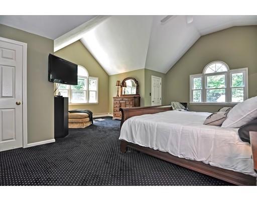 17 Deerfield Drive Medfield, MA 02052 - Photo 30 of 42 a spacious bedroom with a bed a flat screen tv and a large window