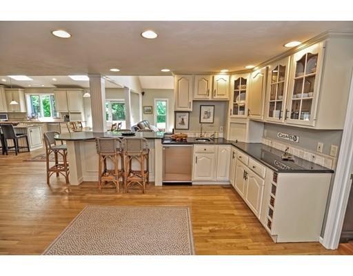 17 Deerfield Drive Medfield, MA 02052 - Photo 9 of 42 a kitchen with stainless steel appliances granite countertop a stove top oven a sink a dining table and chairs