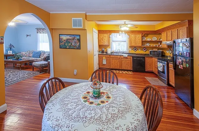 a living room with dining room and wooden floor