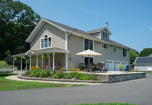 a front view of a house with a yard table and chairs