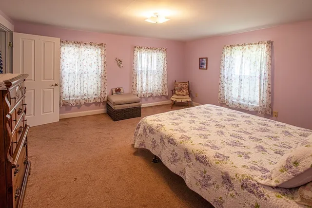 a spacious bedroom with two beds and windows