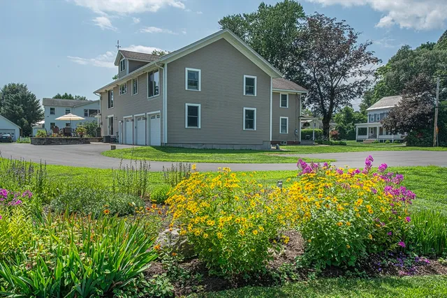 a view of a house with a yard and plants